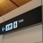 Toilet sign direction at airport